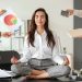 Businesswoman with a lot of work to do meditating in office