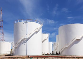 White fuel storage tank against blue sky