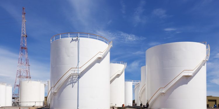 White fuel storage tank against blue sky